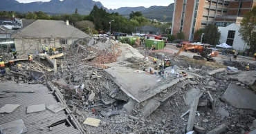 Rescuers contact some workers alive in the rubble of a deadly building collapse in South Africa