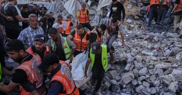 Building damaged in Israeli strikes collapses in Gaza, killing 21