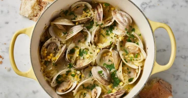 Crème fraîche creates a creamy broth in this recipe for briny-sweet steamed clams