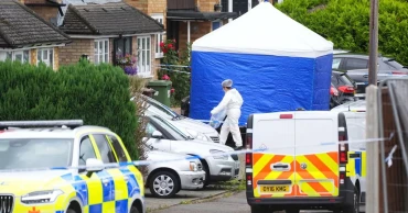 UK police search for man armed with crossbow after 3 women killed in home near London