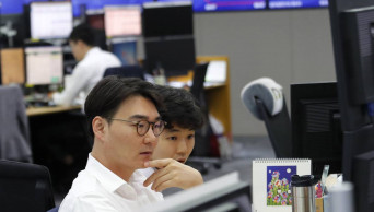 Asian shares mixed as China reports economy slowed in 2Q