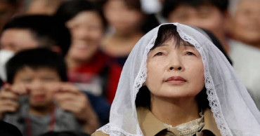 Son of Marine photographer meets pope in Japan