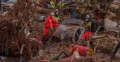 Heavy rains in Barcelona disrupt rail service as troops search for more flood victims in Valencia