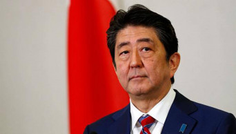 Japan PM visits storm-hit areas; royal parade may be delayed