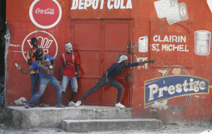 Thousands of protesters in Haiti loot stores, battle police