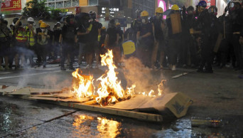 Hong Kong protesters surround police station