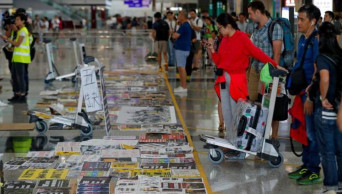 Flights restart at Hong Kong airport as protesters apologize