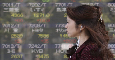 Asian markets advance following record Dow close