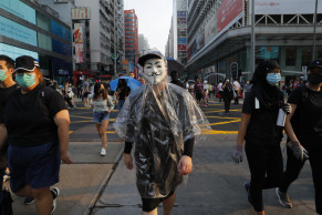 Thousands march again, gas bombs thrown in Hong Kong