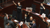Chaos halts Hong Kong leader's speech; activist attacked
