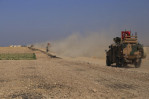 Turkish, Kurdish forces battle for border town in NE Syria