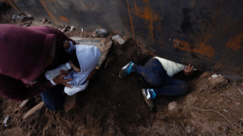 Migrants in Tijuana trickling over and under wall